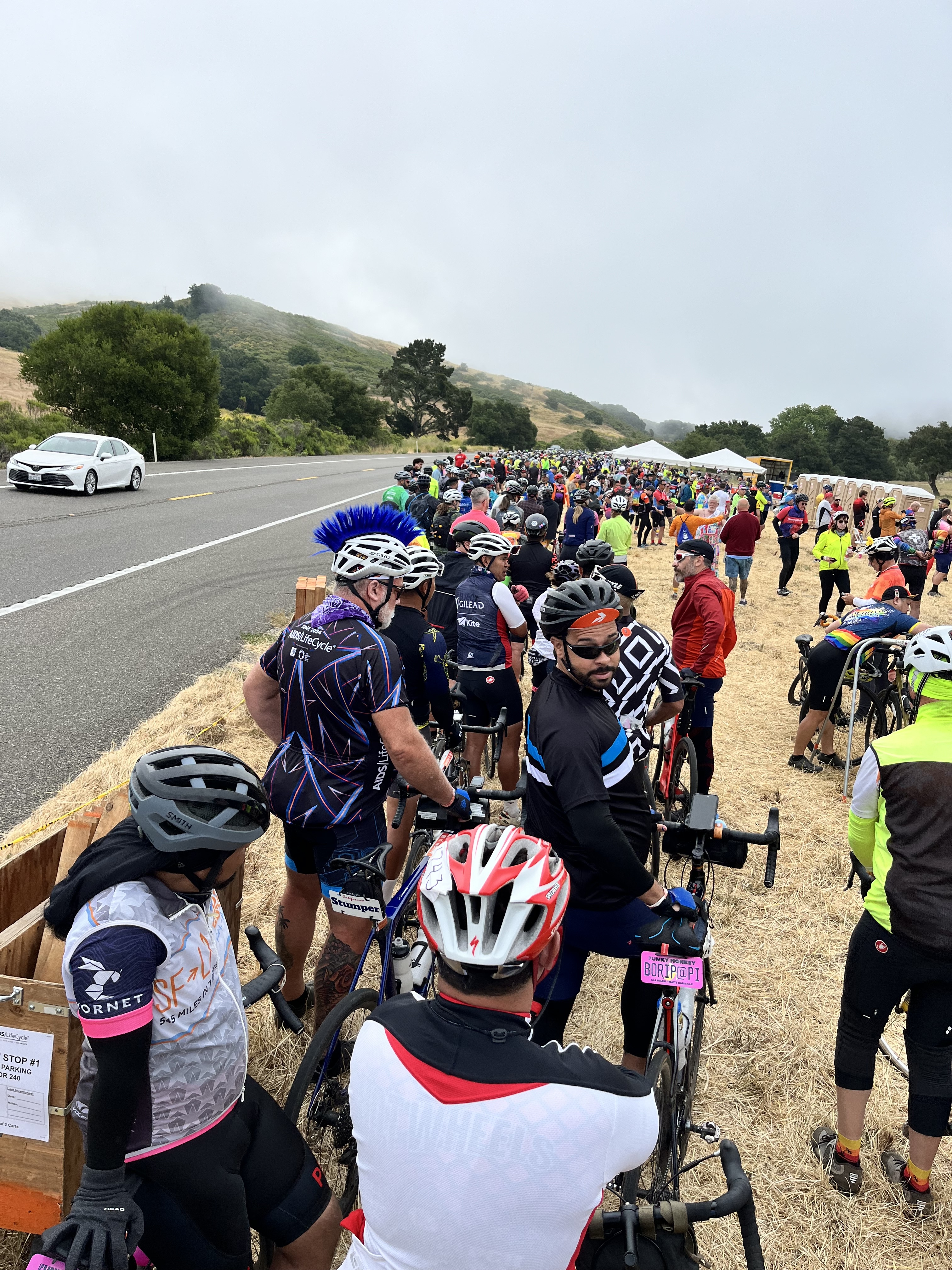 Long line of cyclists waiting to be let back on the road